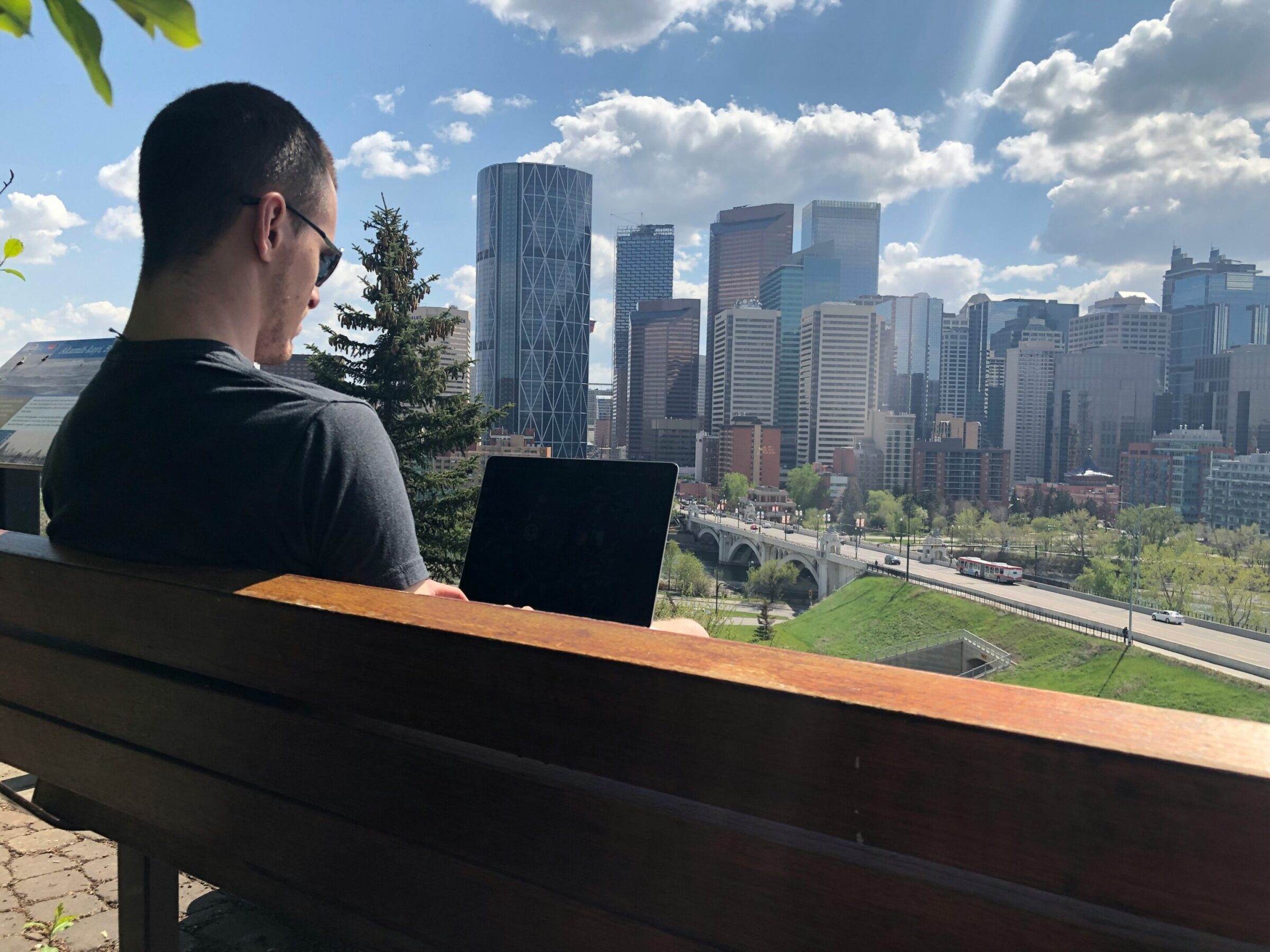Man sitting on bench using laptop and cognitive agility