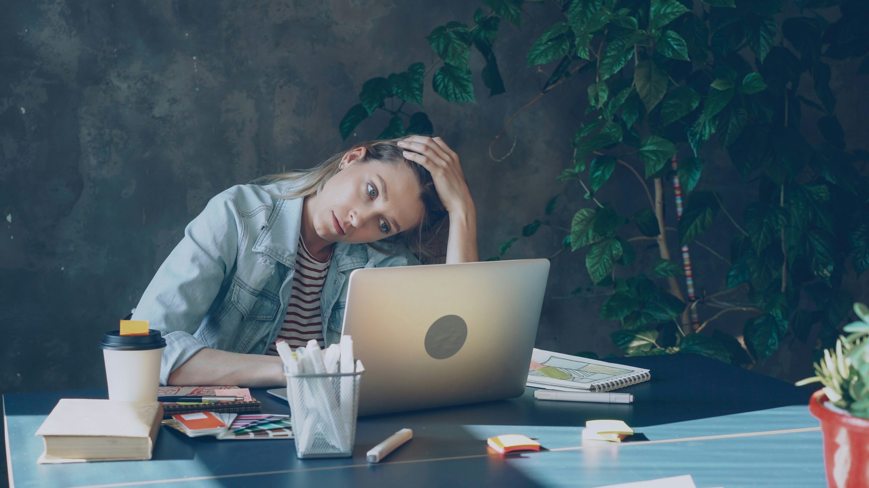 Lady managing stress on laptop